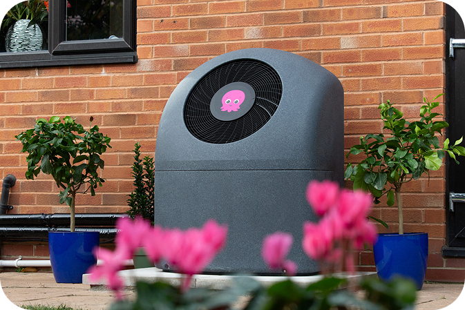 Cosy heat pump behind home.