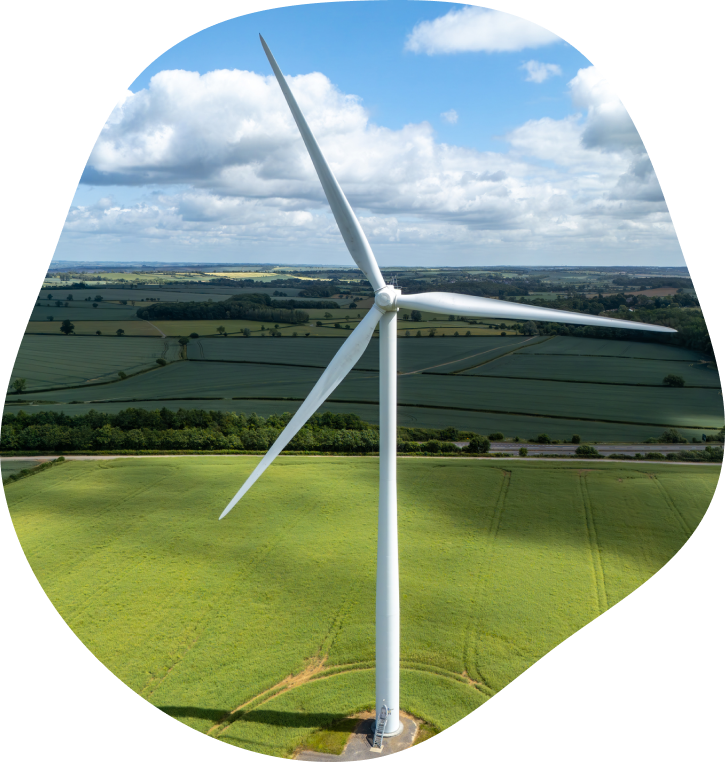 A wind turbine with rolling hills behind it