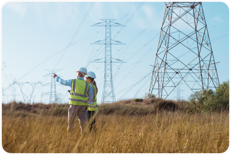 Engineers in a field with bylons