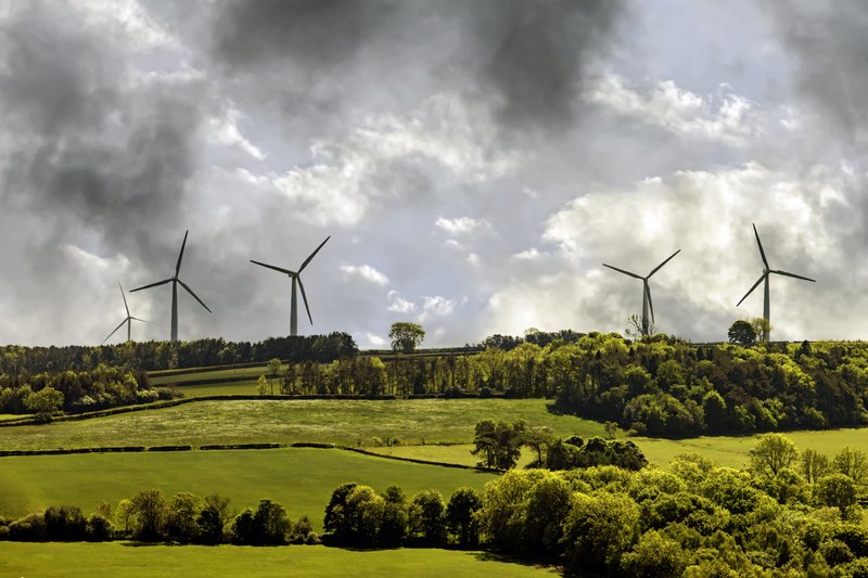 Windmills backdropped by a cloudy sky