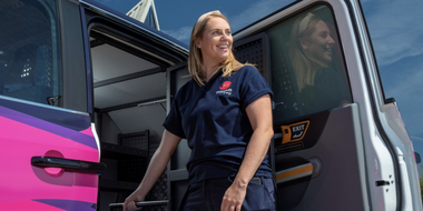 Engineer pulling tools out of electric van