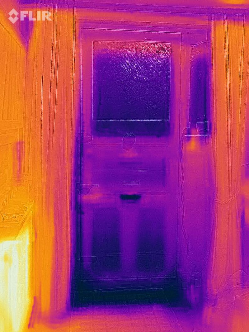 An image of a draughty door with the curtains left open