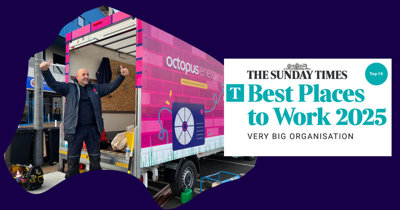 man in van with arms up and a 'best place to work' placard