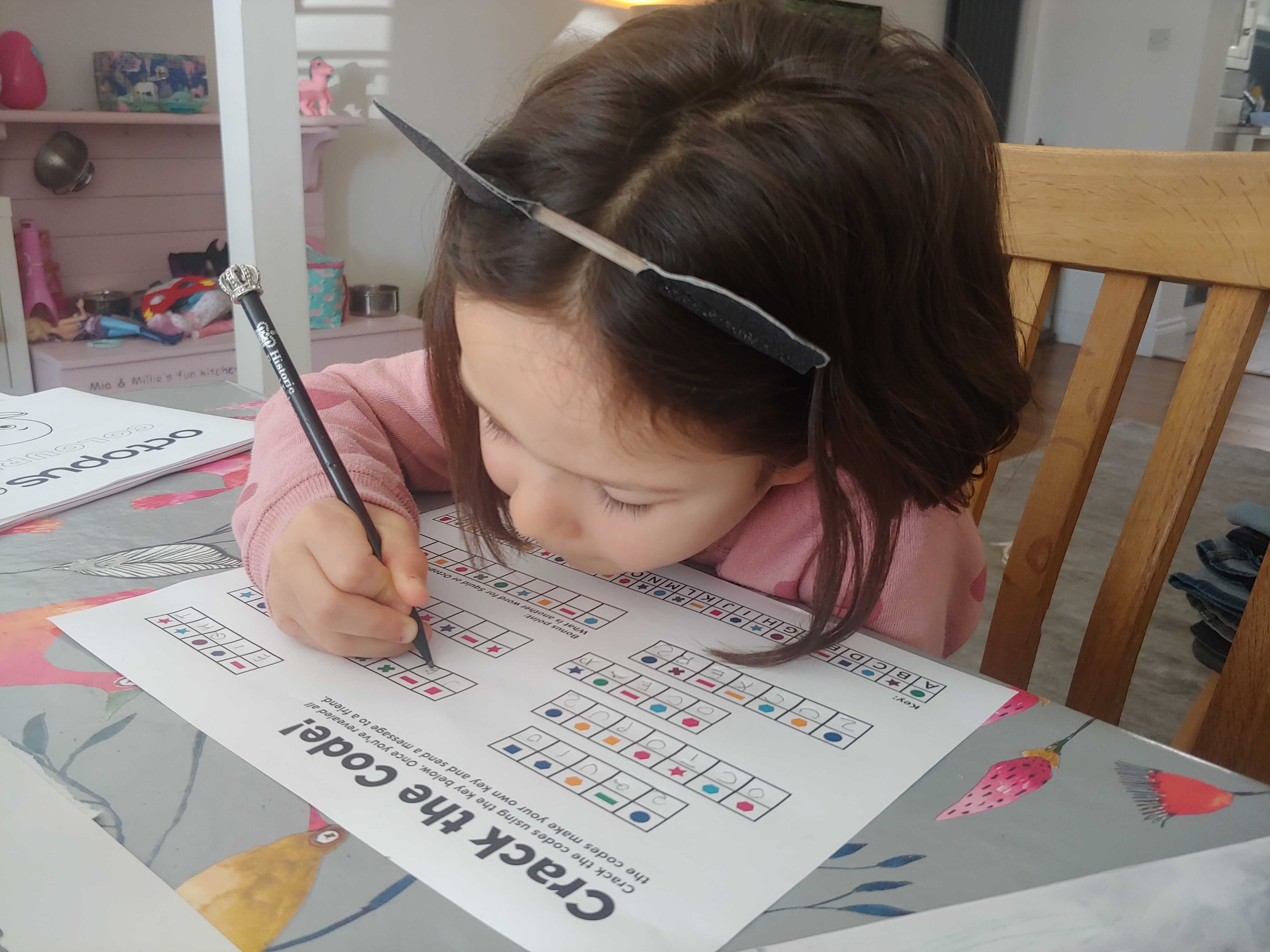 An image of a child filling out an Octokids activity sheet