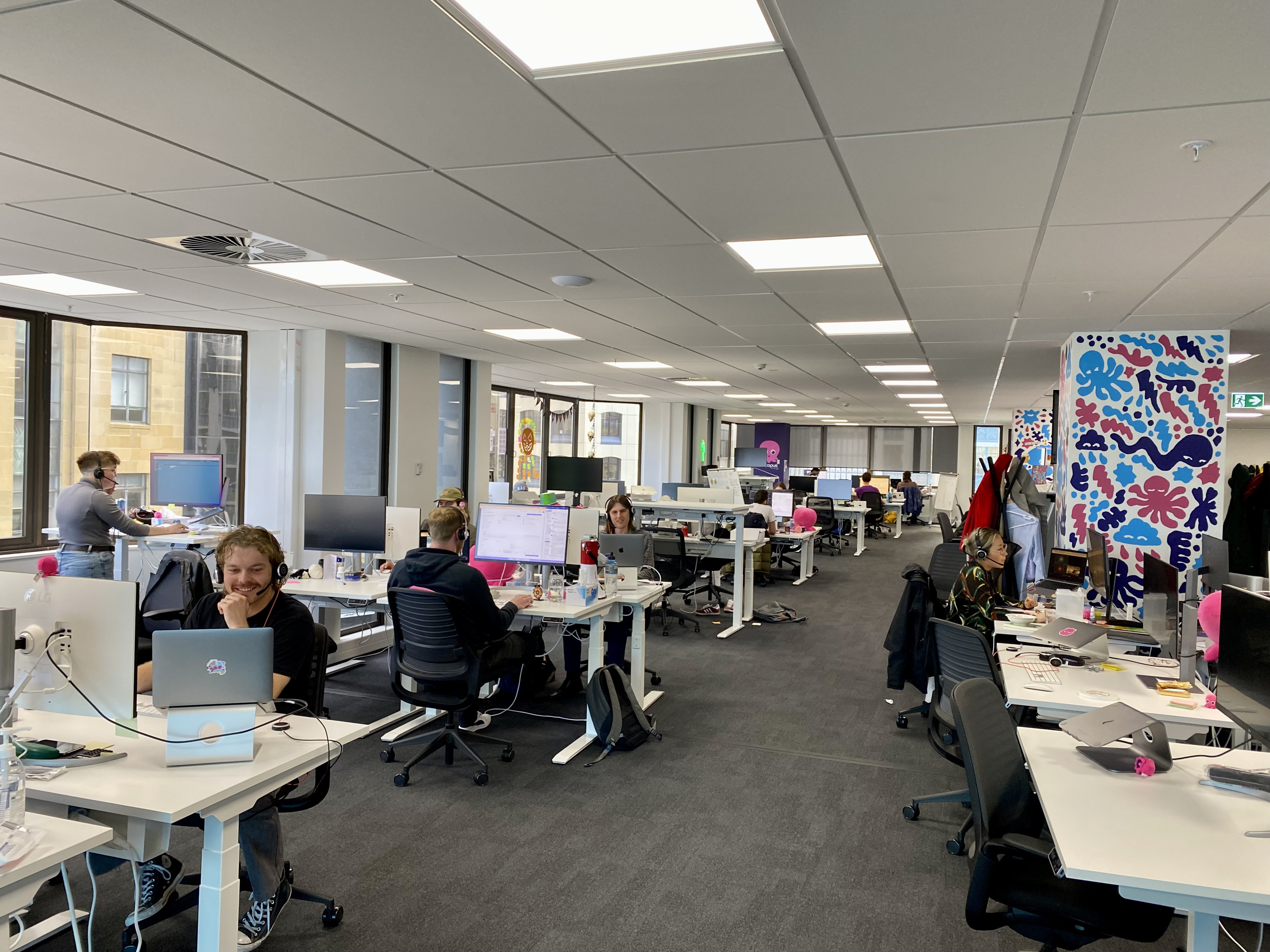 picture of the new zealand office with ops members taking calls