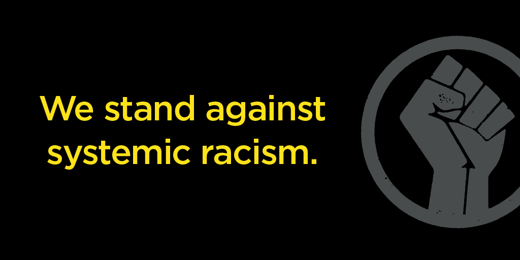 an image of a fist against a black background that says: we stand against systemic racism.