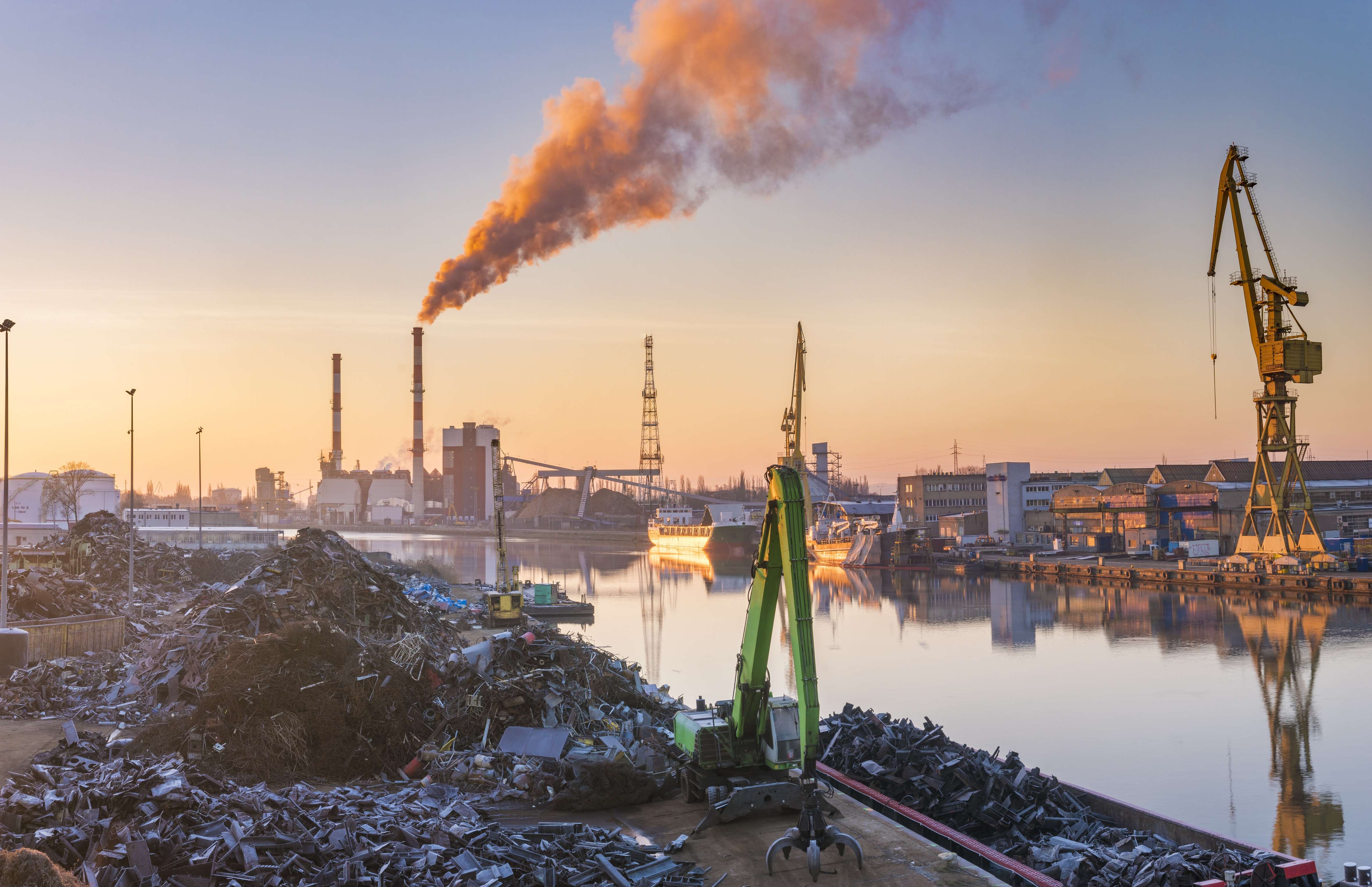 image of smokestacks by a river in china