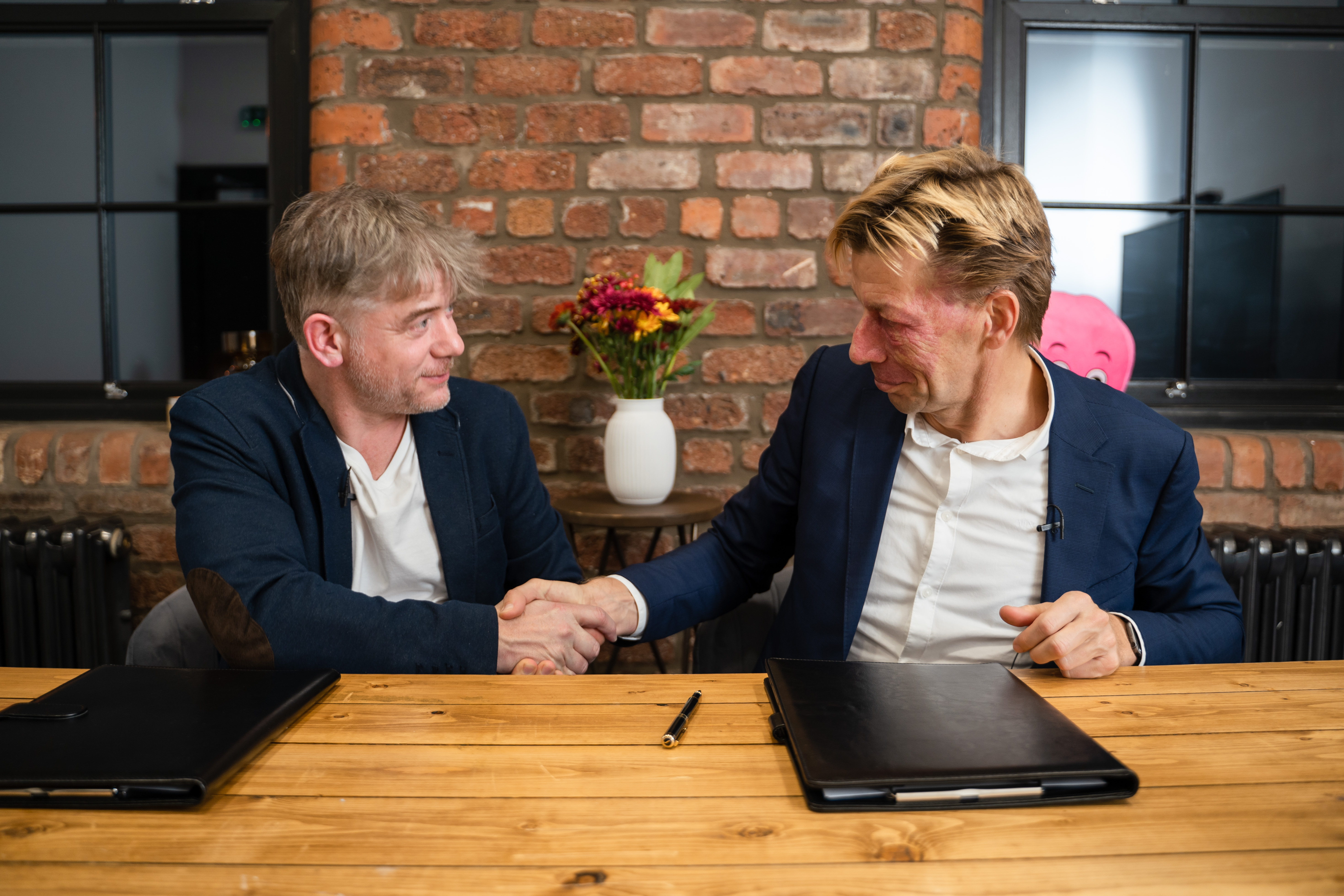 Greg Jackson and Chris Peeters shaking hands over contract