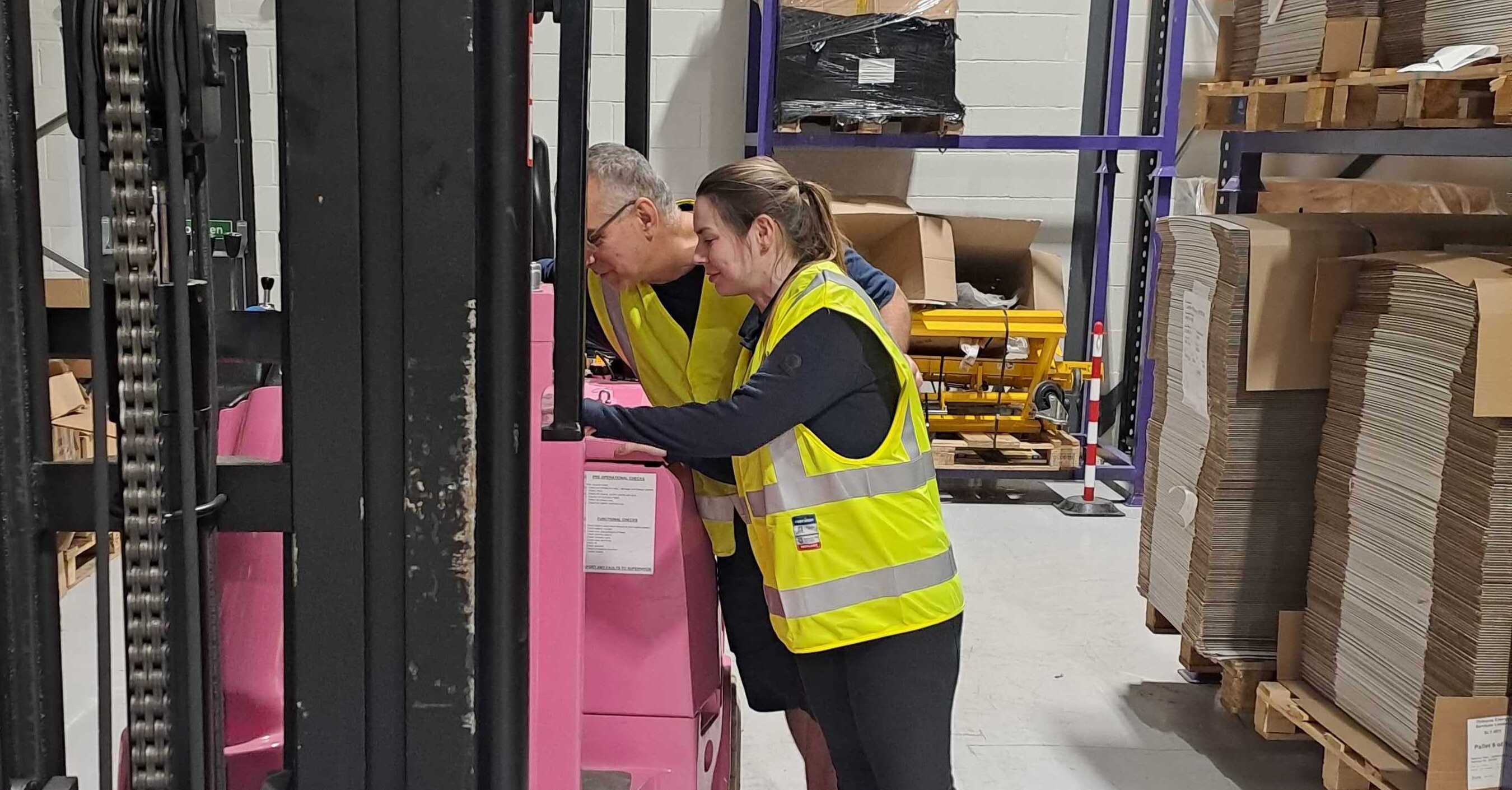 a picture of ceri and her team mate working in the offices