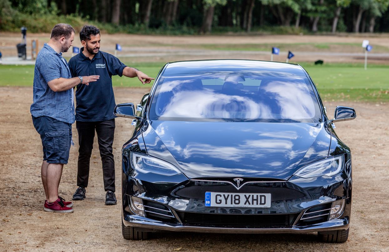 Gurjeet showing a customer a car