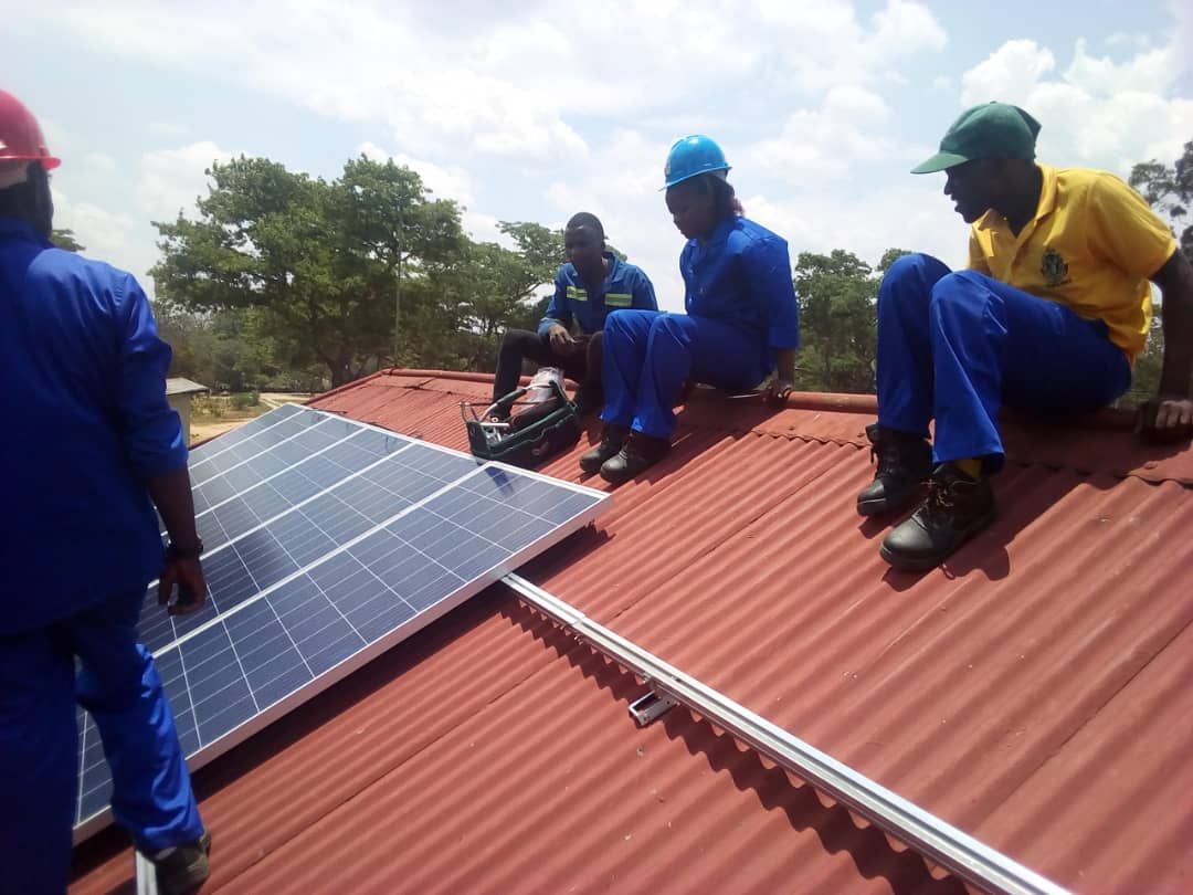 An image of a team installing solar panels