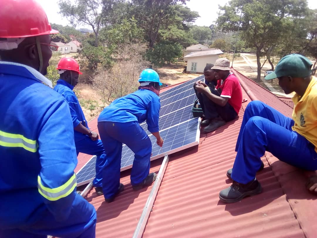 An image of a team installing solar panels