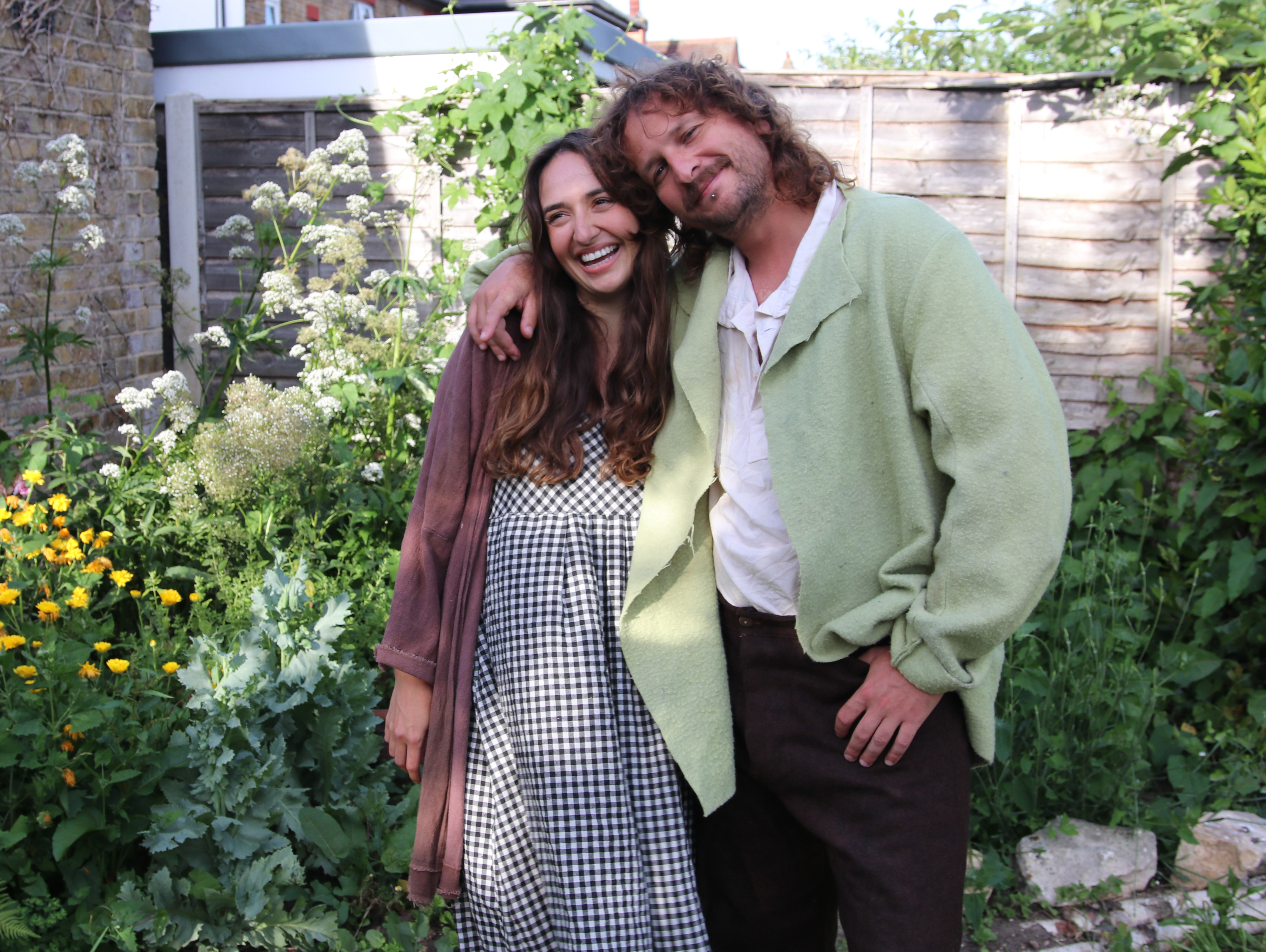 Max and Louise smiling in their garden