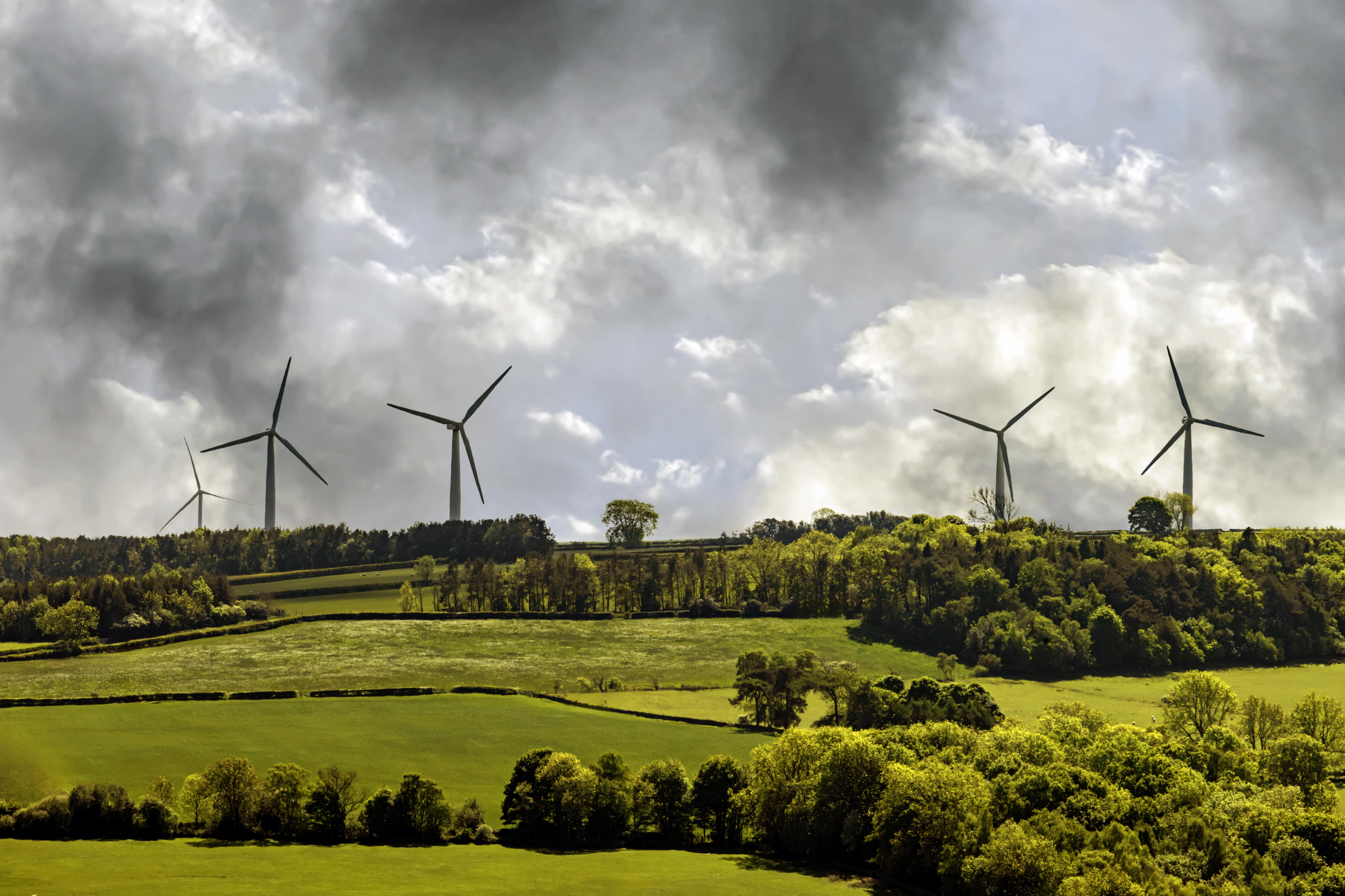 Windmills backdropped by a cloudy sky