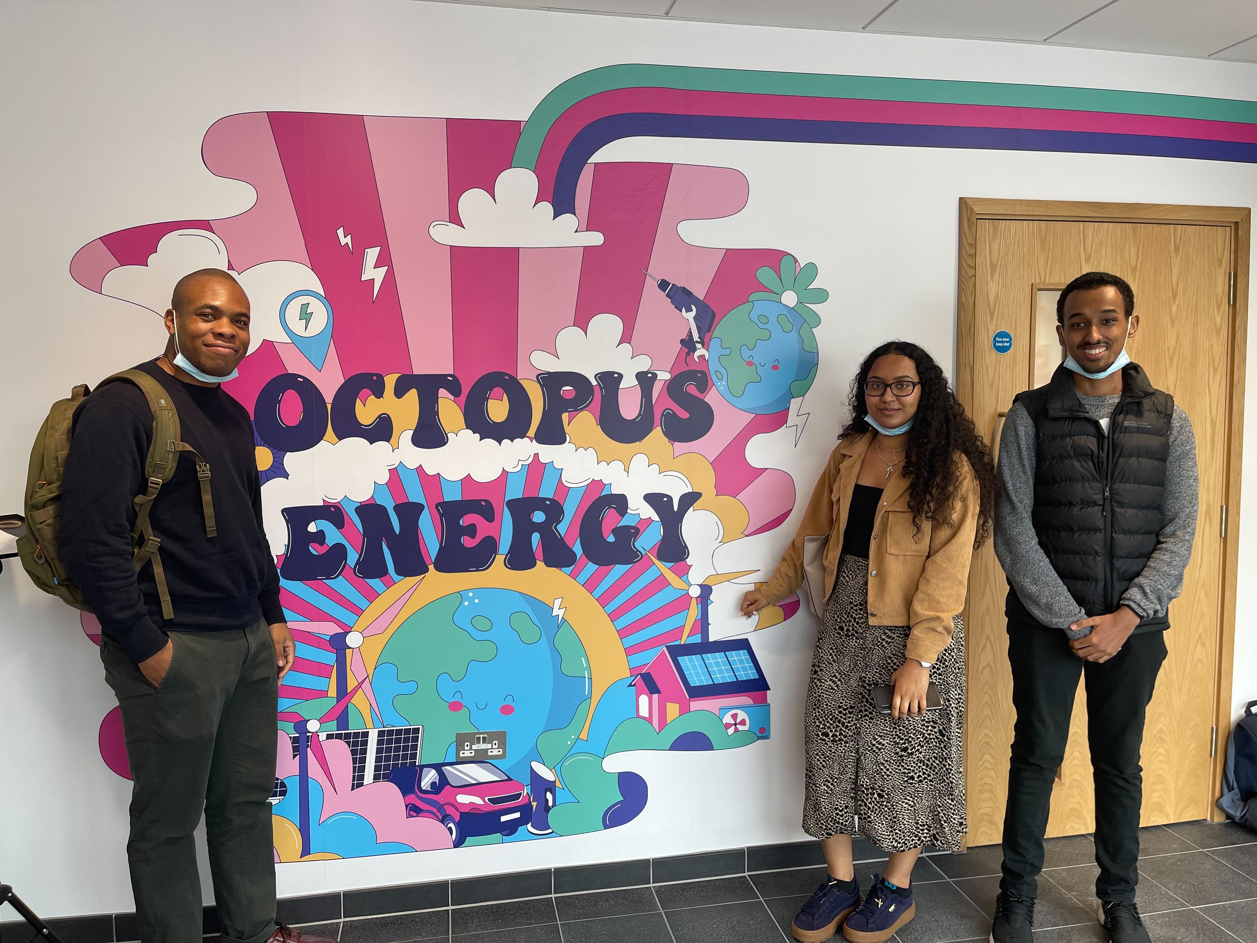 A picture of the interns in front of an Octo sign