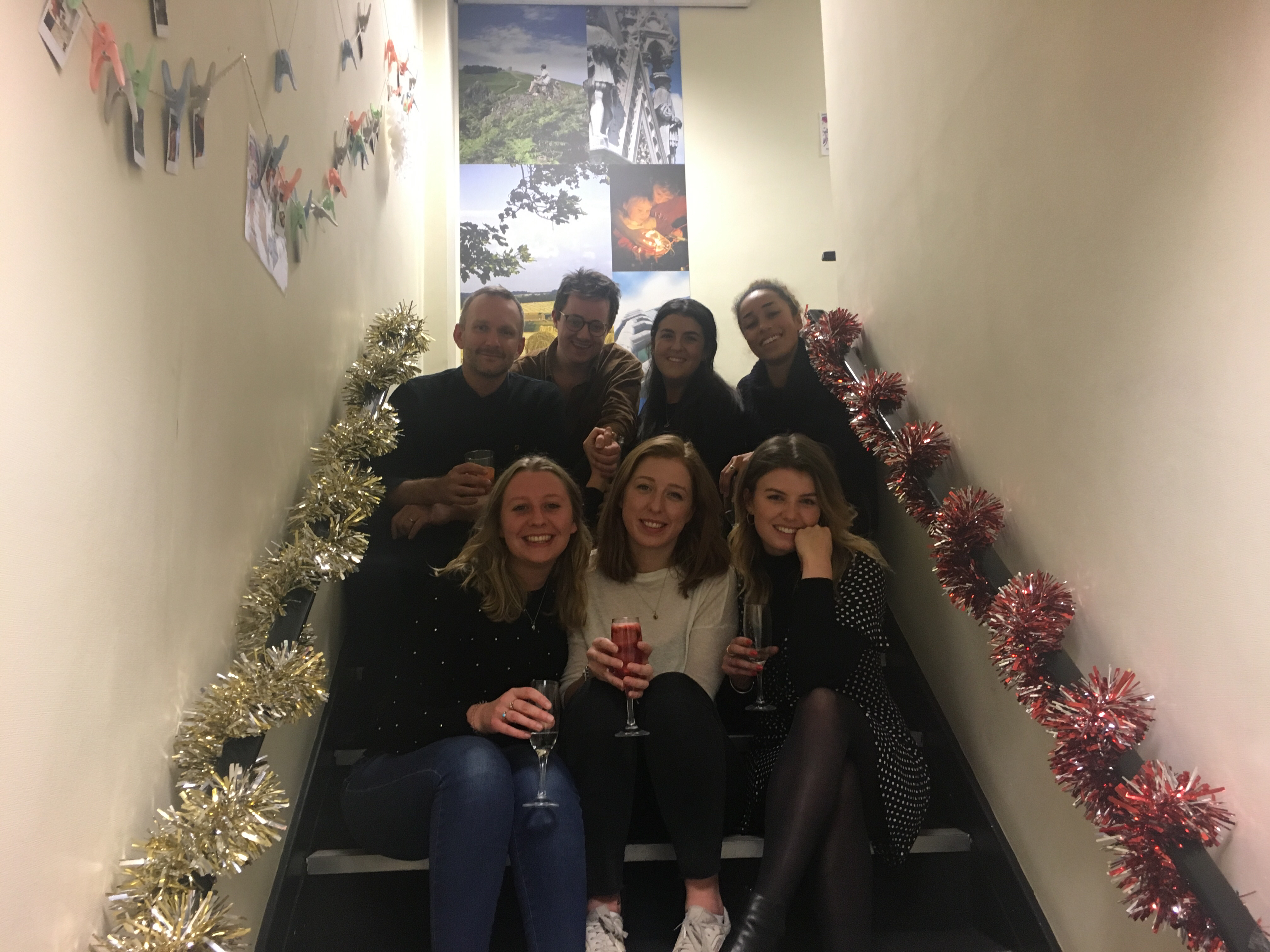 The Octopus Energy operations leadership team sitting on the steps in our Leicester office