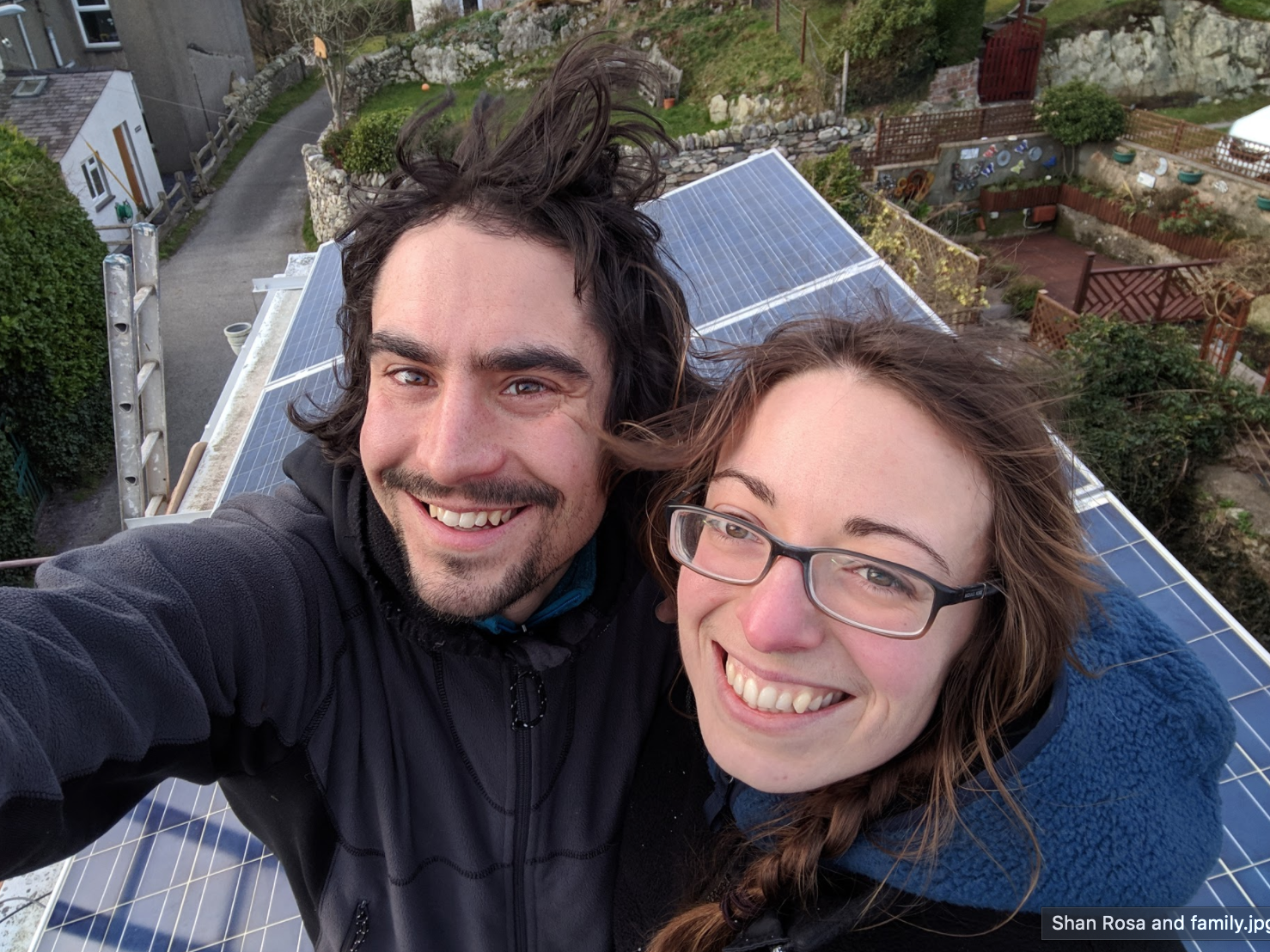 A photo of Glyn and Amy with their home solar panels