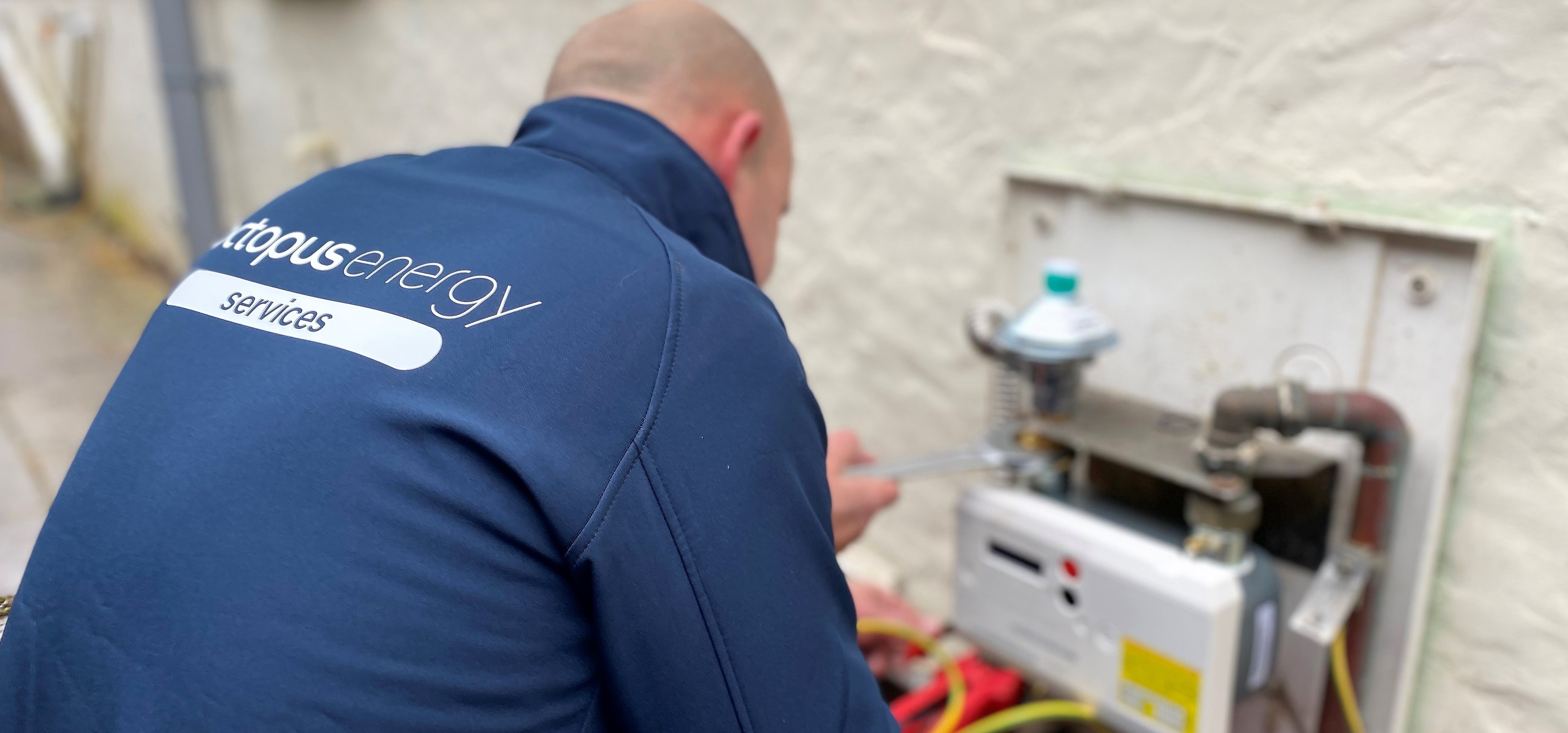 An Octopus Energy Services engineer installing a smart meter