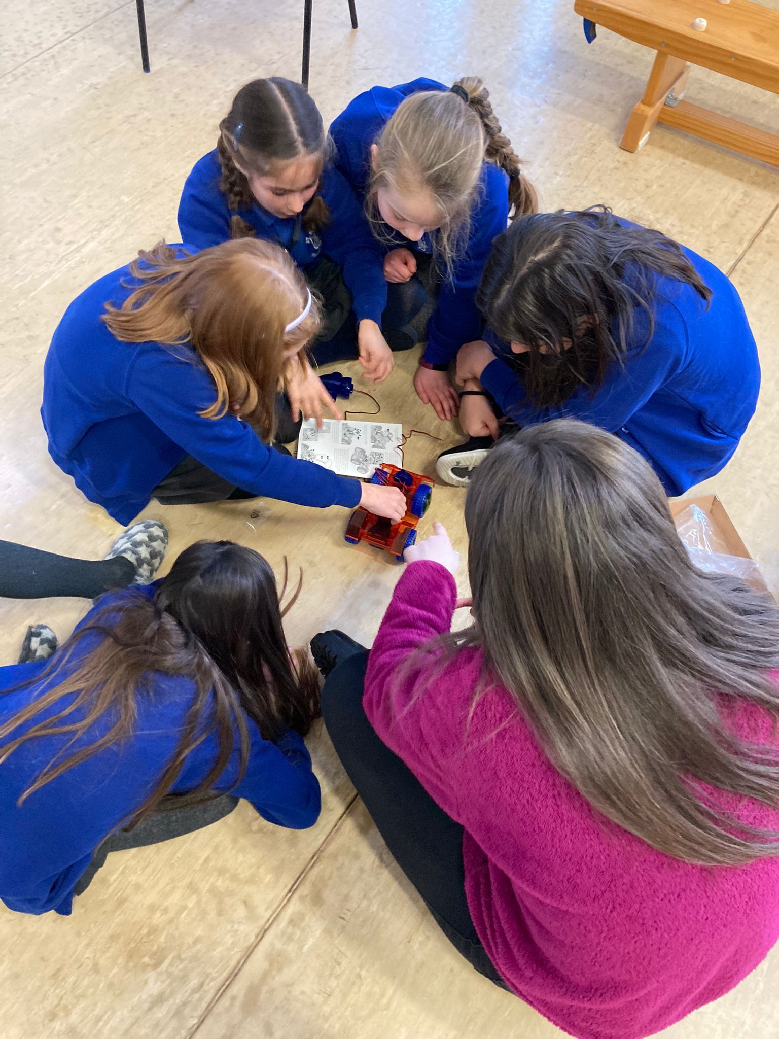 Kids designing a sign for Fan club