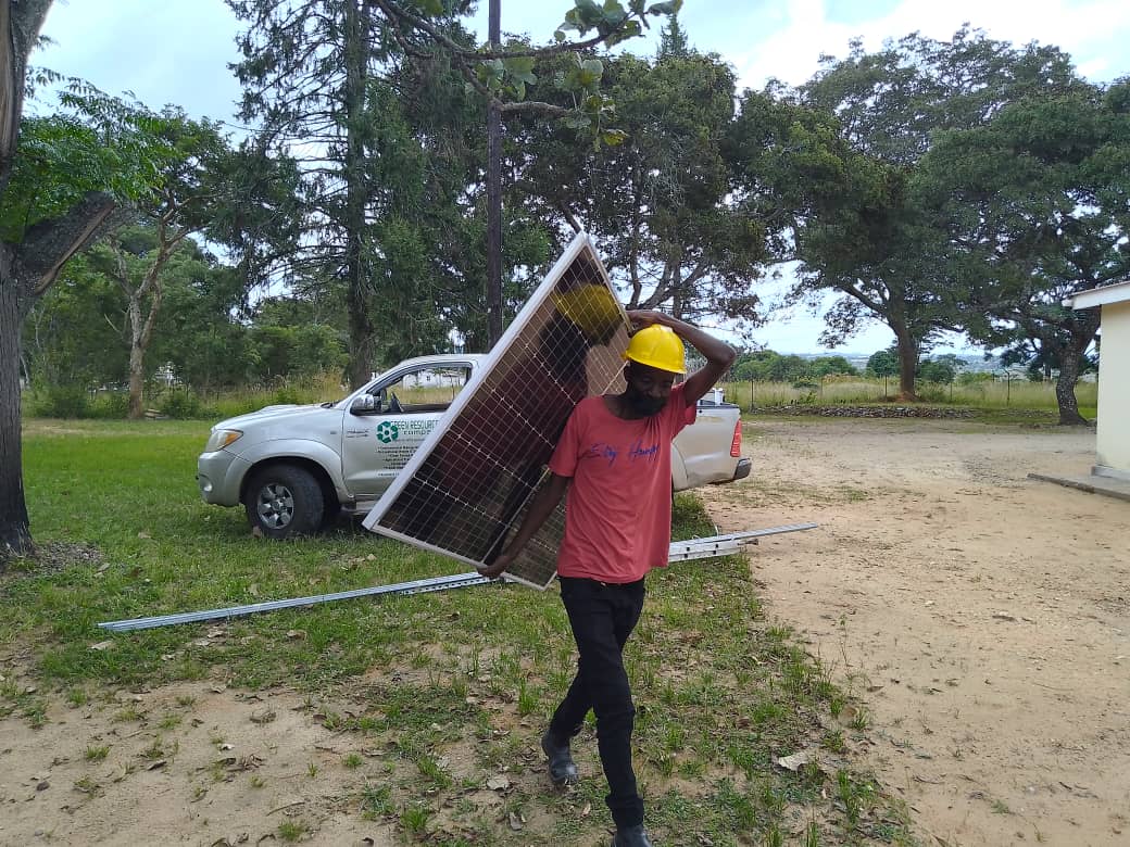 man carrying solar panel