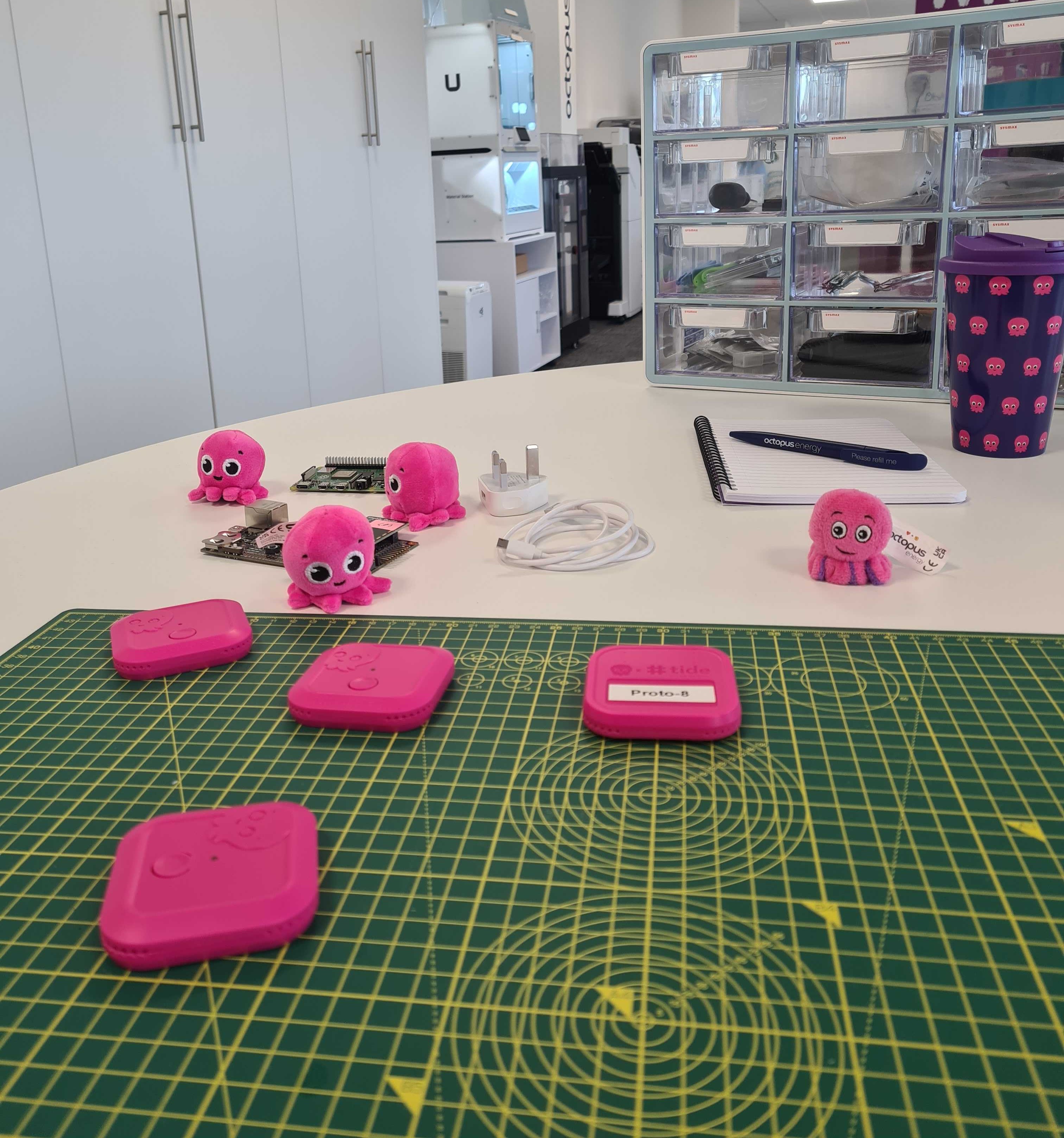 4 pink octopus home mini's placed on a table in the office