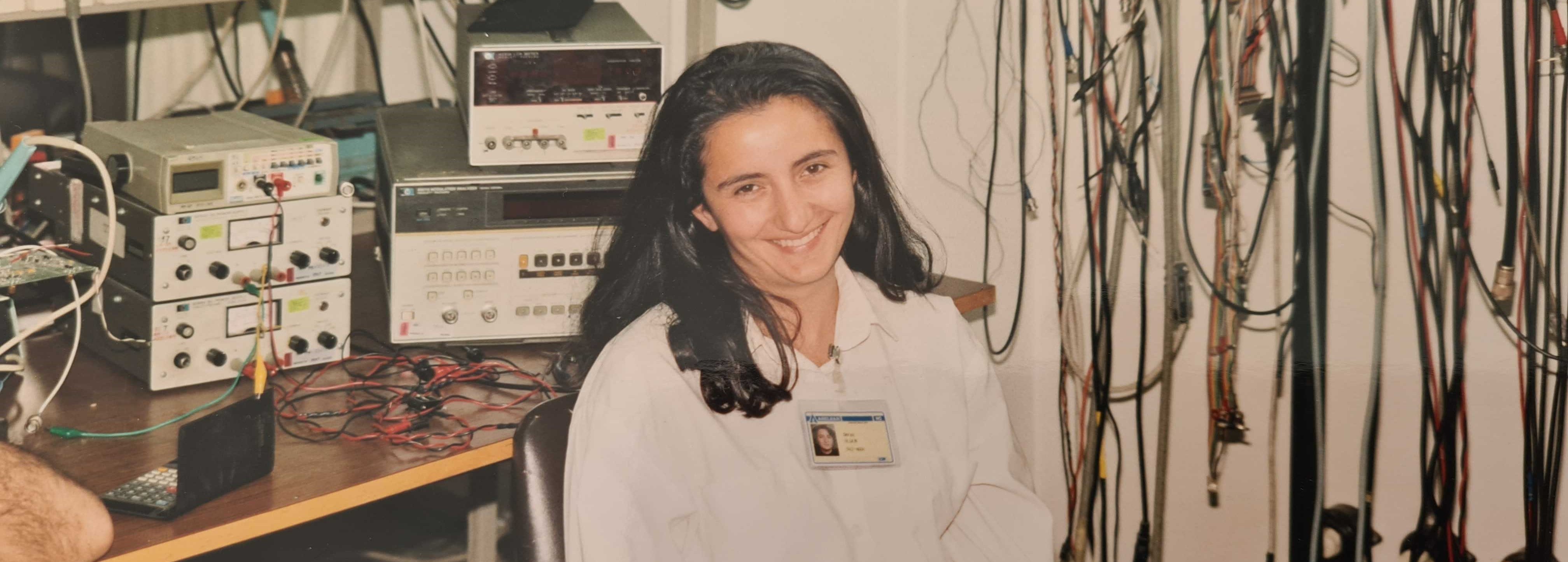 Derya back in the 90's sitting in a room full of computer equipment