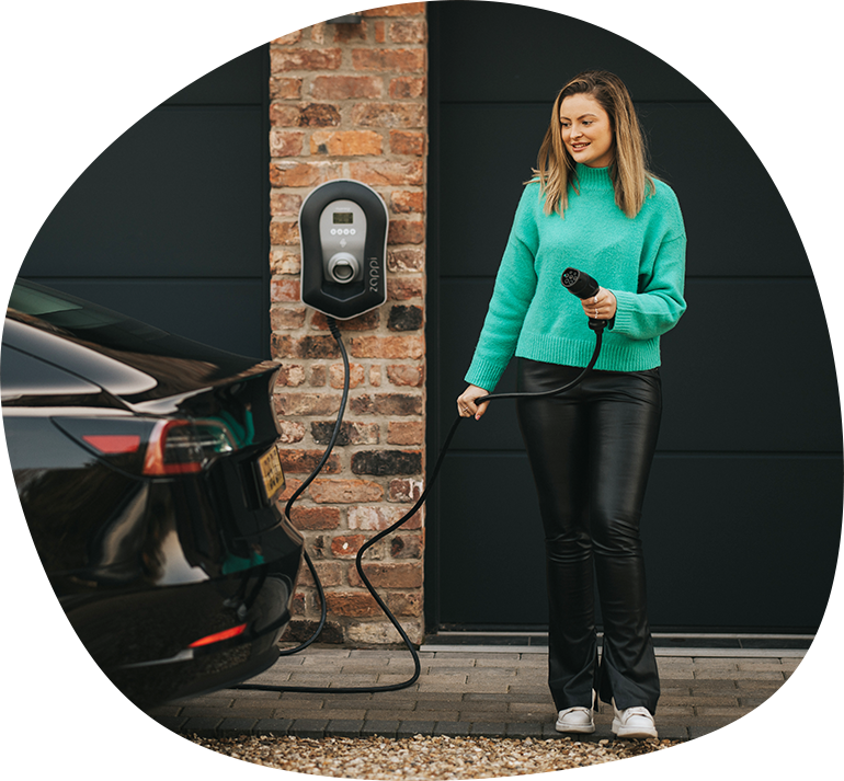 Woman charging EV outside house
