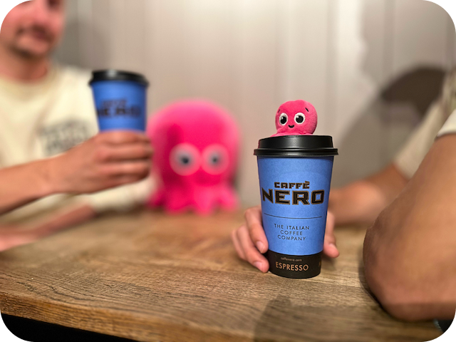 Costa coffee cup with little constantine plushie on top