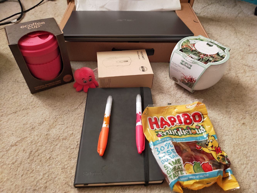 A picture of some octo-goodies (sweets, pens, an octopus keep cup, and some little toy octopuses)