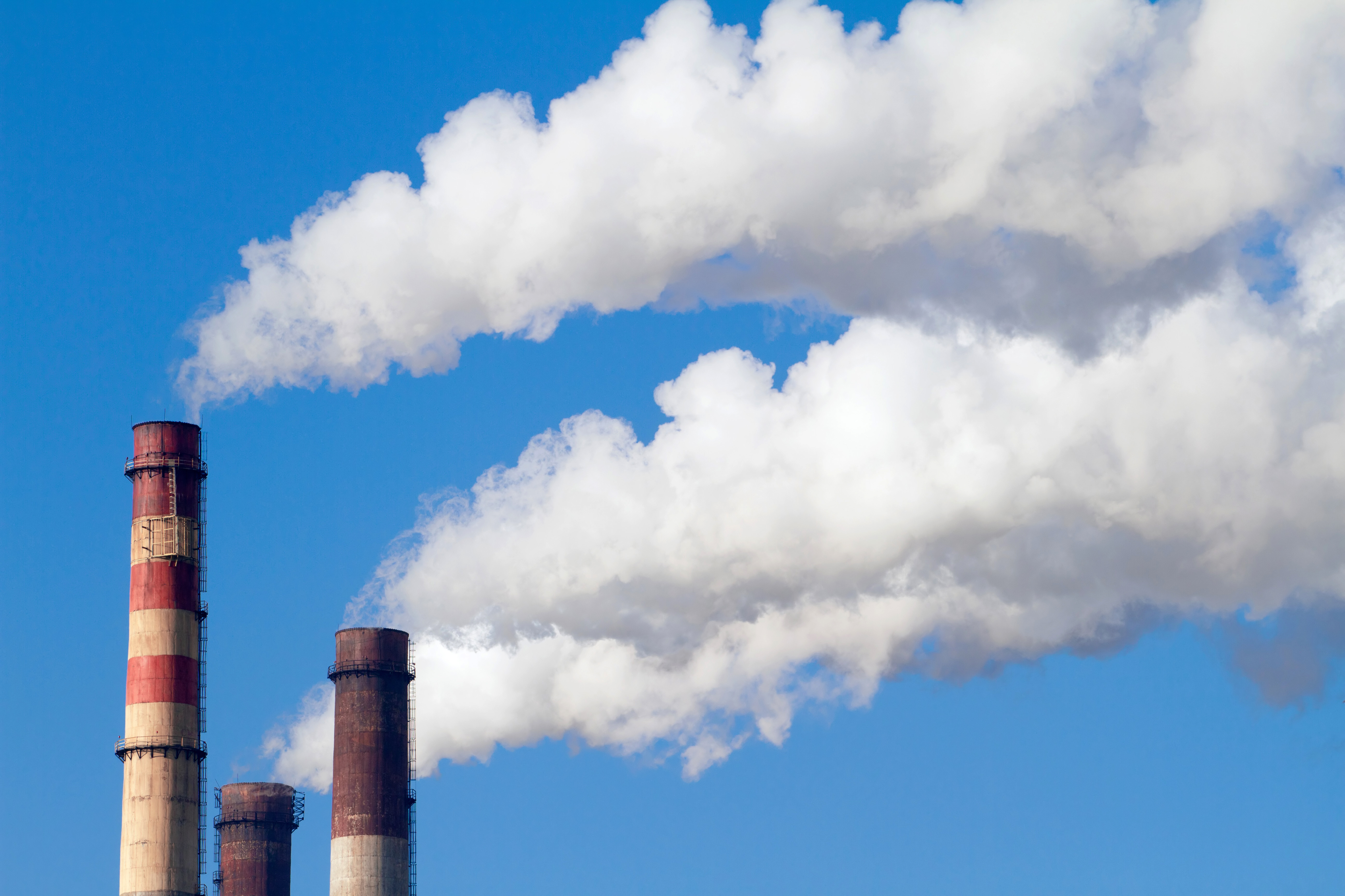 an image of chimneys pouring smoke